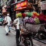 Auch Blumen in allen Farben kann man von den Damen auf dem Fahrrad kaufen